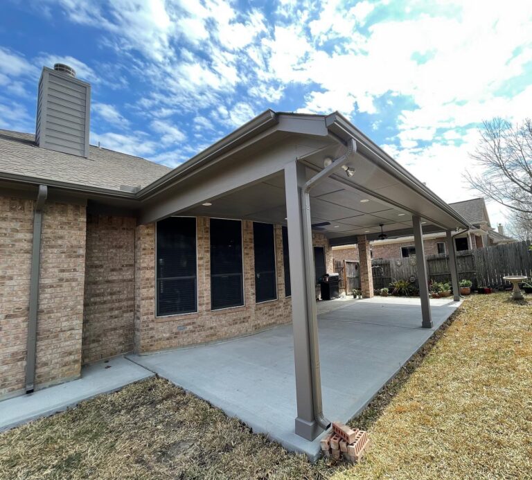 Seamless gutters along the roofline of a covered backyard patio
