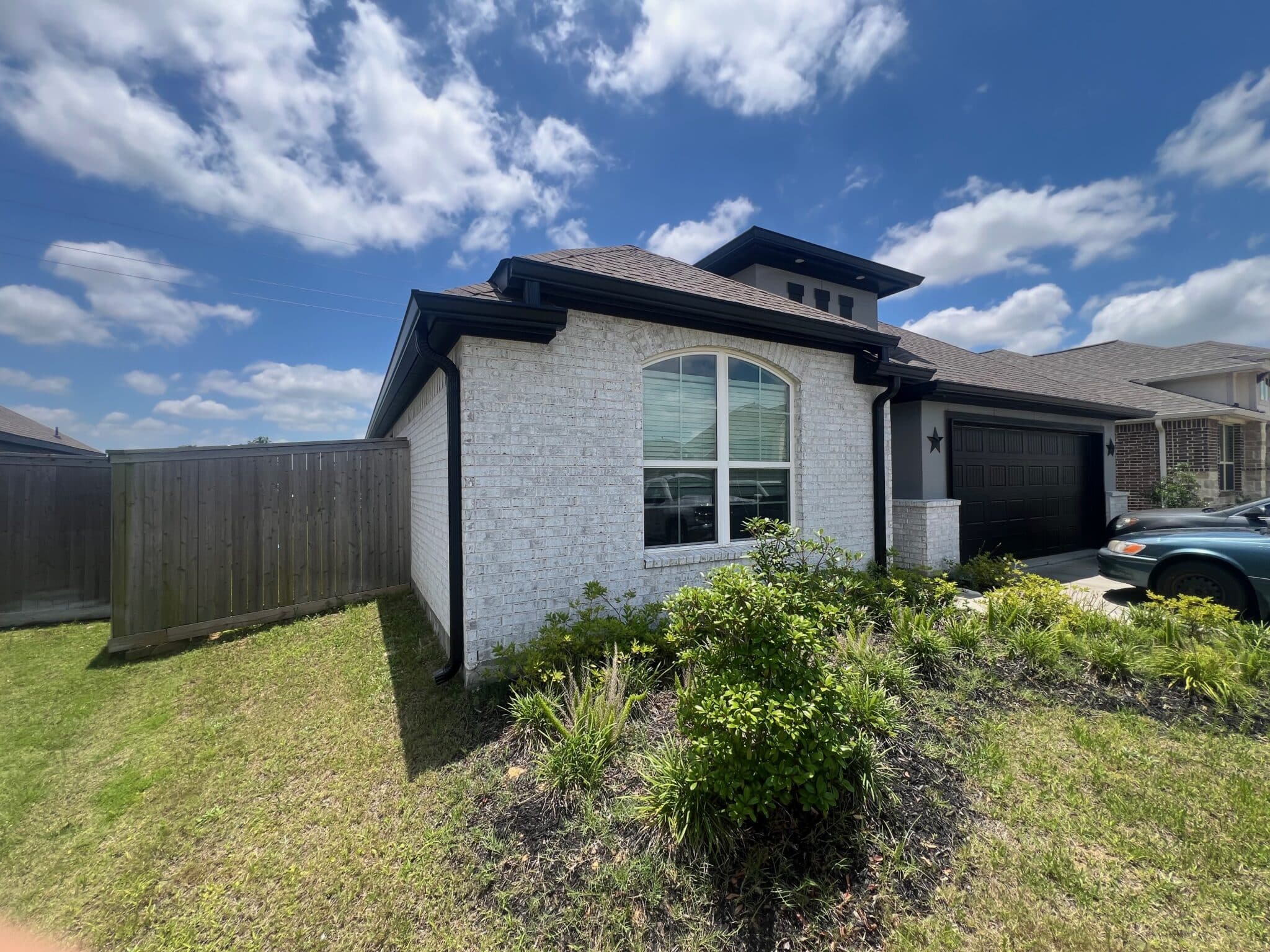 Black seamless gutters installed on a Texas home
