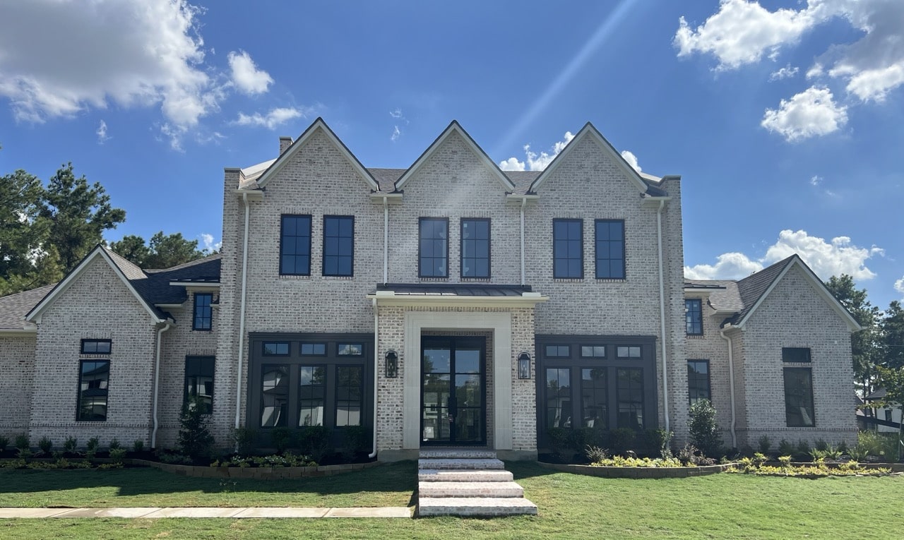 Completed gutter system on a large brick home